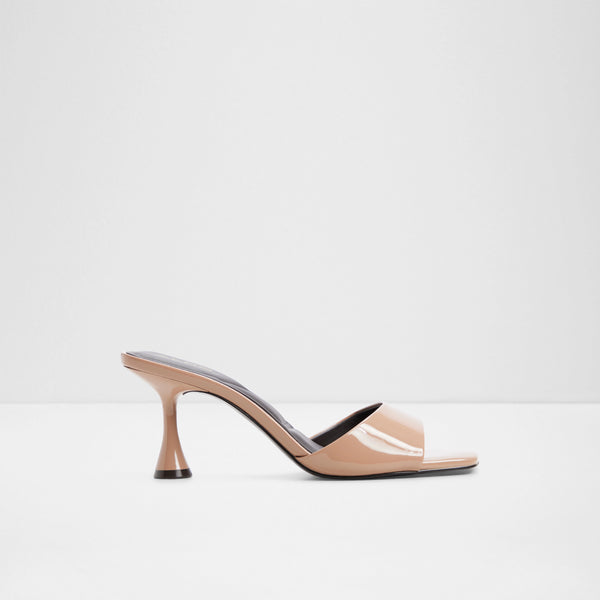 ALDO Alathia beige patent heeled mule sandal featuring a glossy finish, a wide single toe strap, an open square toe, and a sculptural flared heel, displayed against a light grey background.