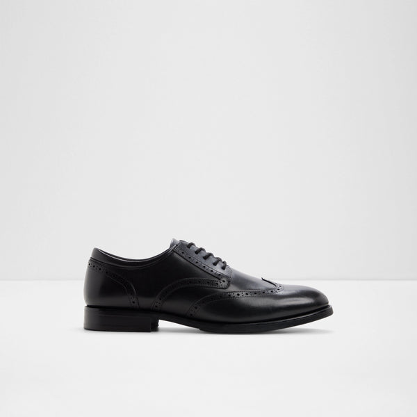 ALDO Harington men's black leather wingtip brogue dress shoe featuring decorative brogue perforations, classic lace-up closure, a rounded toe, and a durable low block heel, displayed against a light grey background.