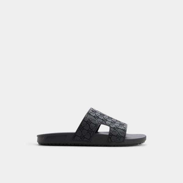 Black slide sandal with textured strap on a white background