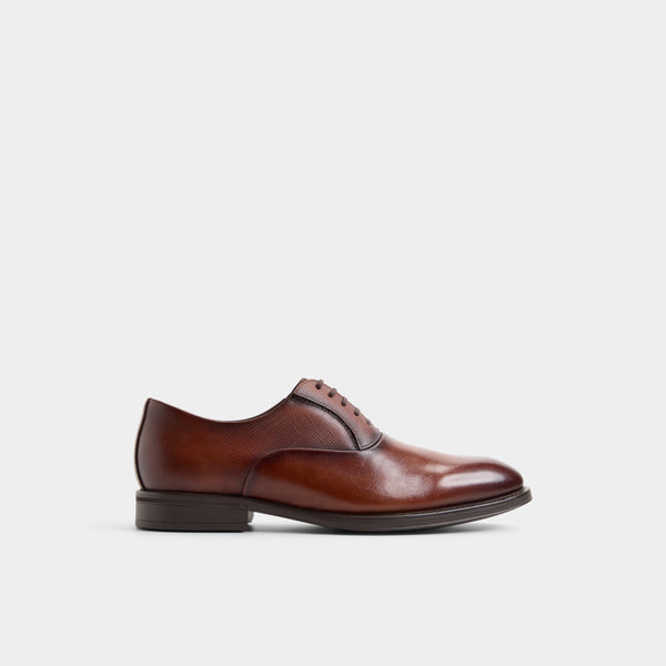 A single brown leather lace-up dress shoe shown in side profile against a plain light gray background.