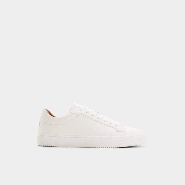 A minimalist white leather low-top sneaker shown from a side profile against a clean, light gray background.